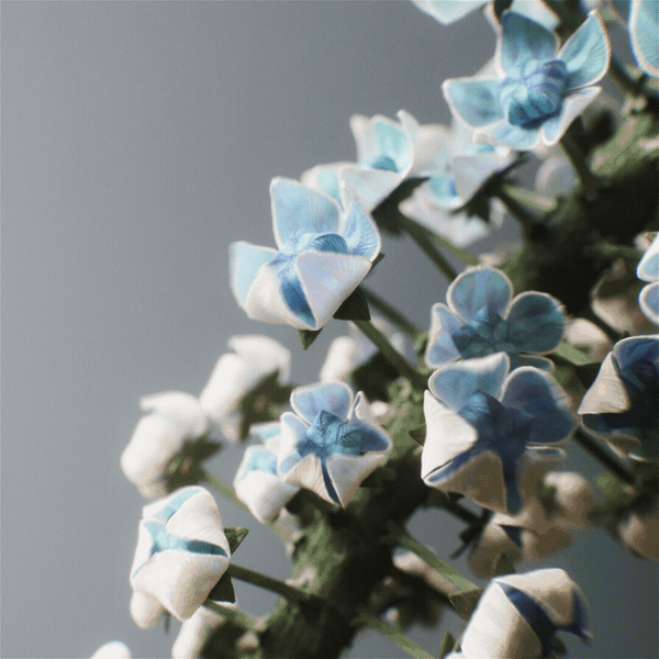 a gif of a detail of a 3D-rendered imaginary flower with blue flowers that bloom ever tinier like Russian dolls