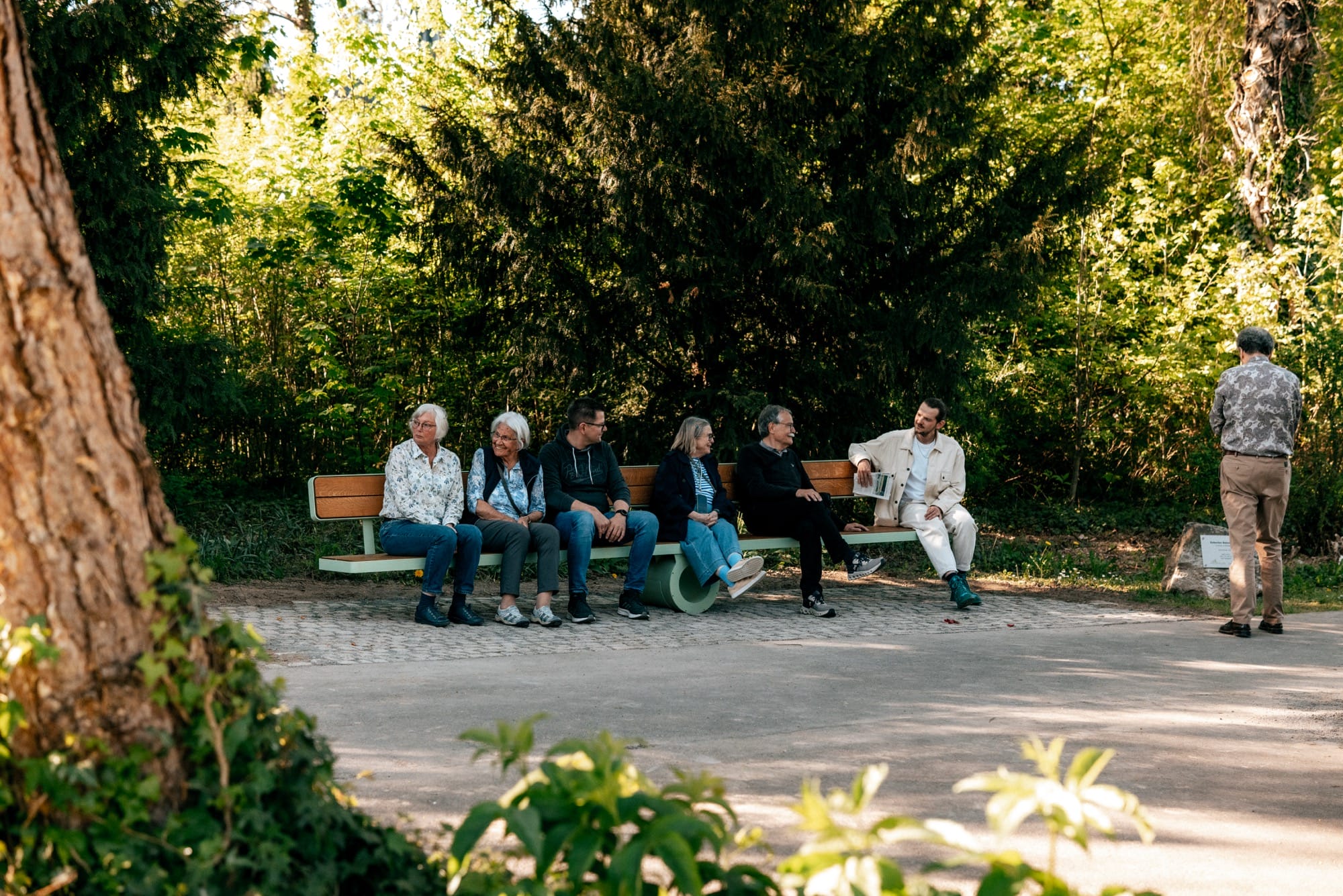 a bench sits perfectly flat  as people balance on either side