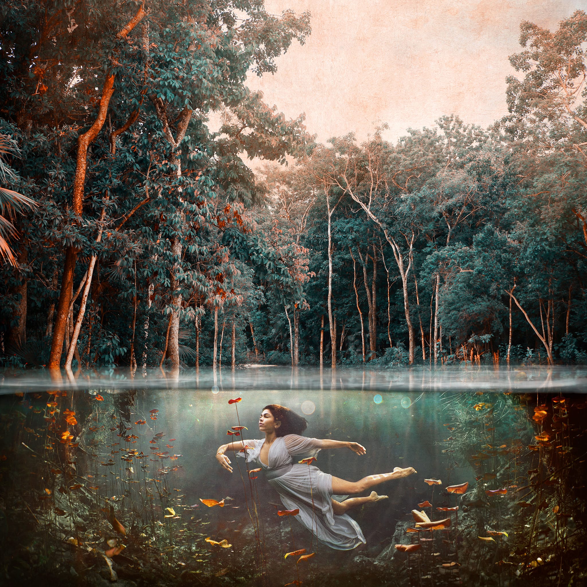 Photograph of girl dancing underwater showing both the scenery above and below the water.