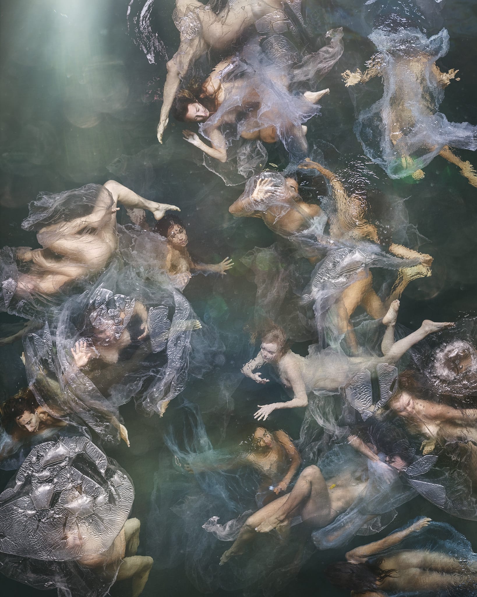 Aerial photograph of people swimming with soft fabric.