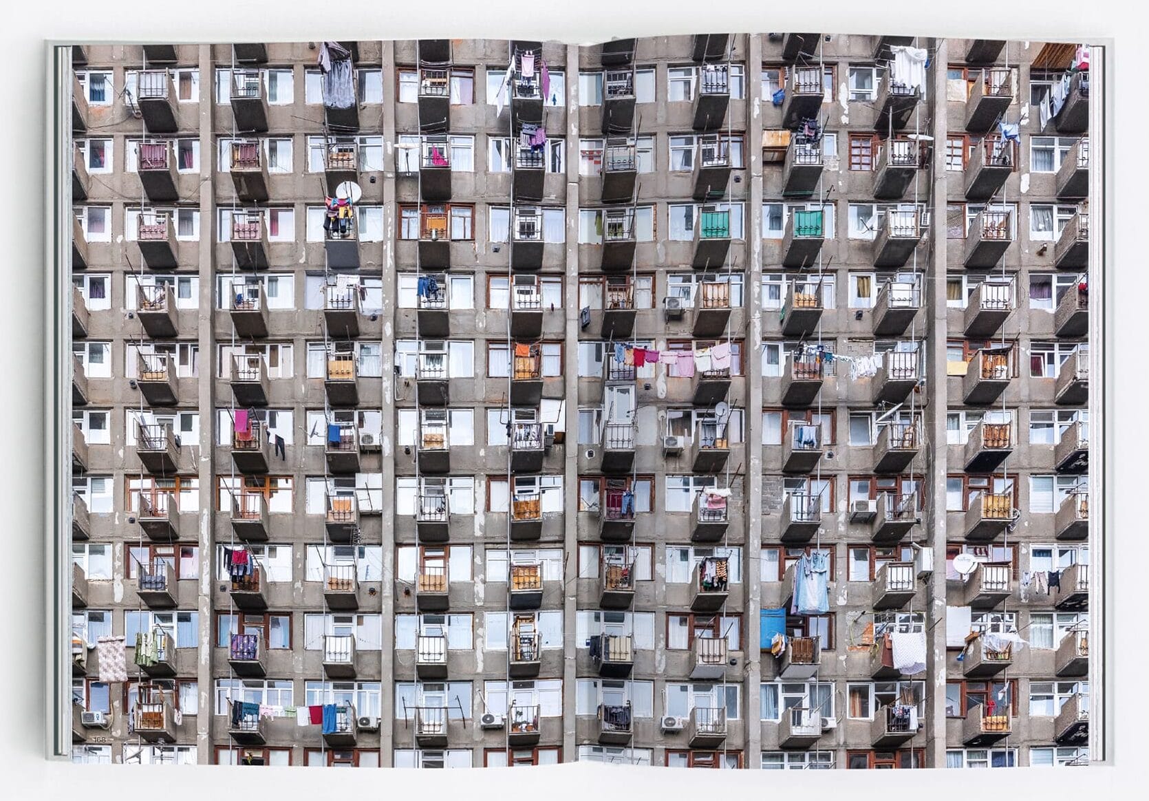 a spread from the book 'Eastern Blocks II' featuring a full-bleed photo of numerous residential windows in a huge building