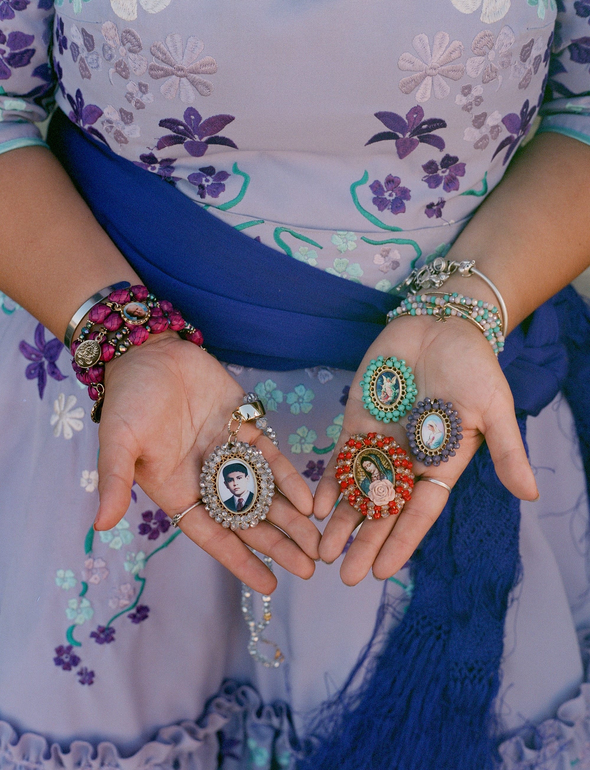 a woman in a dress holds small photographs in her hands