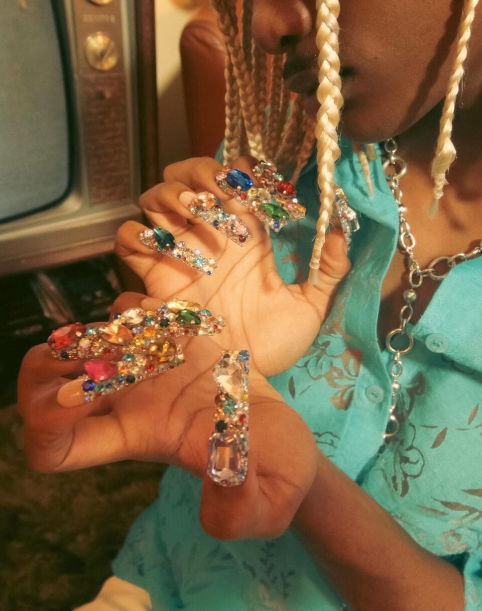 a long maximalist manicure consisting of dense clusters of jewels