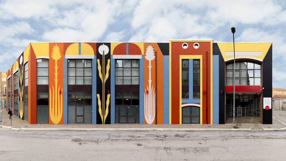 a colorful, geometric mural on the side of a wide building