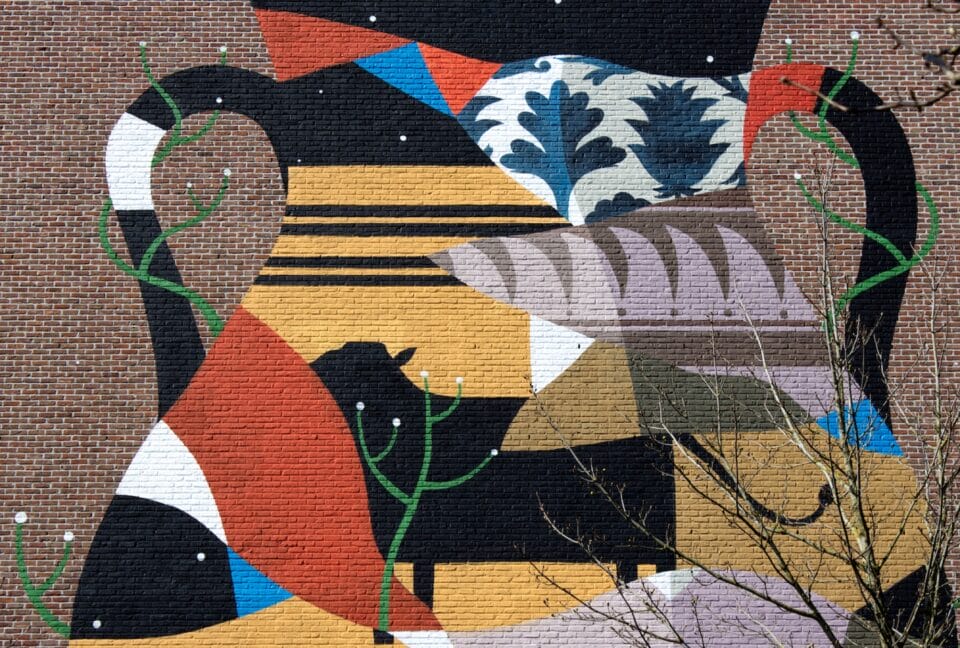 a detail of a large-scale mural on a brick surface with abstract color blocks