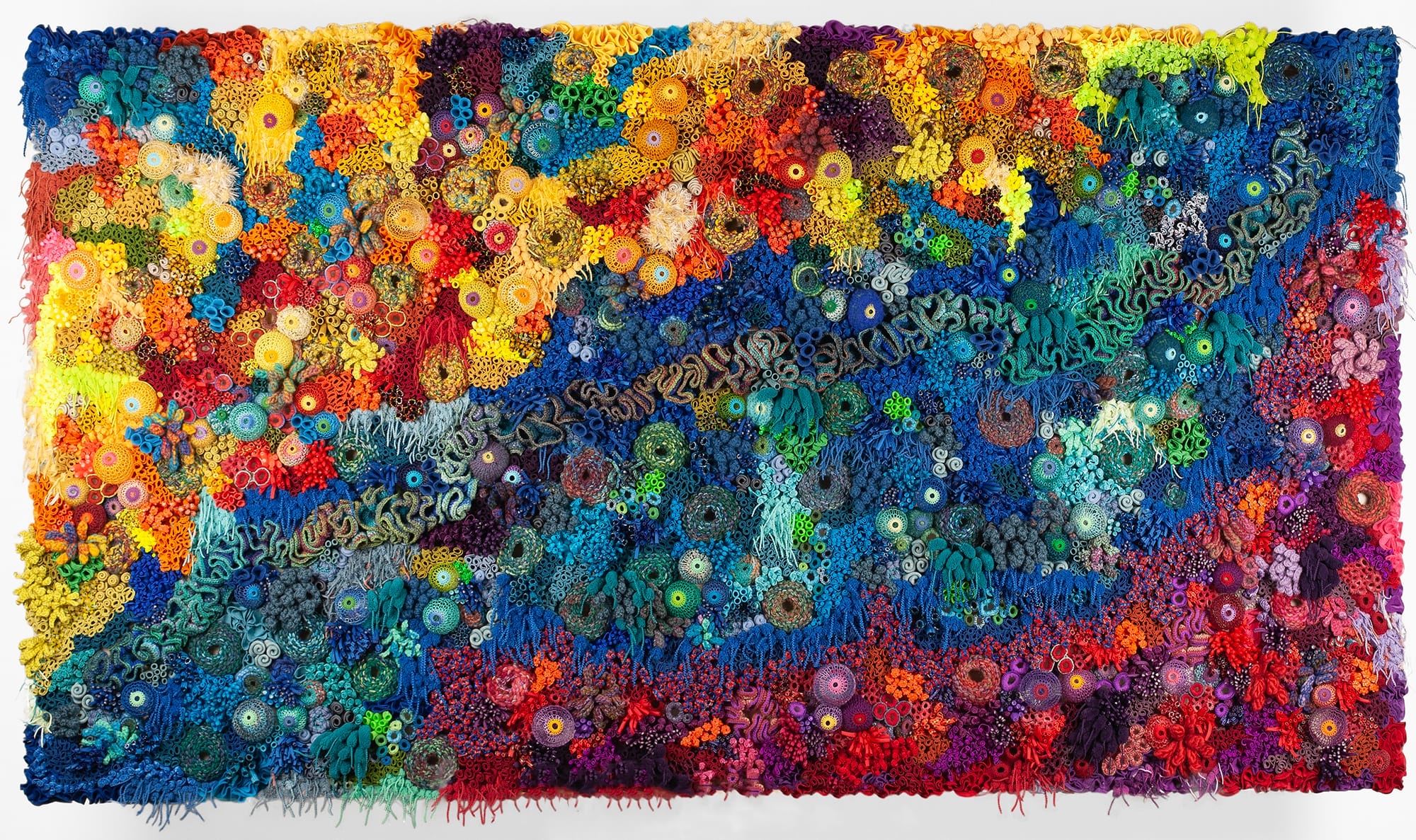 a vibrant fiber work evoking corals, molds, and other organic forms