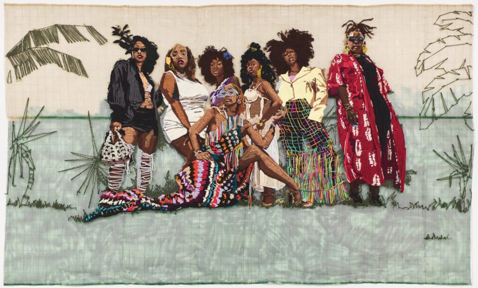 a large-scale embroidered group portrait of vibrantly-dressed Black women in a natural landscape