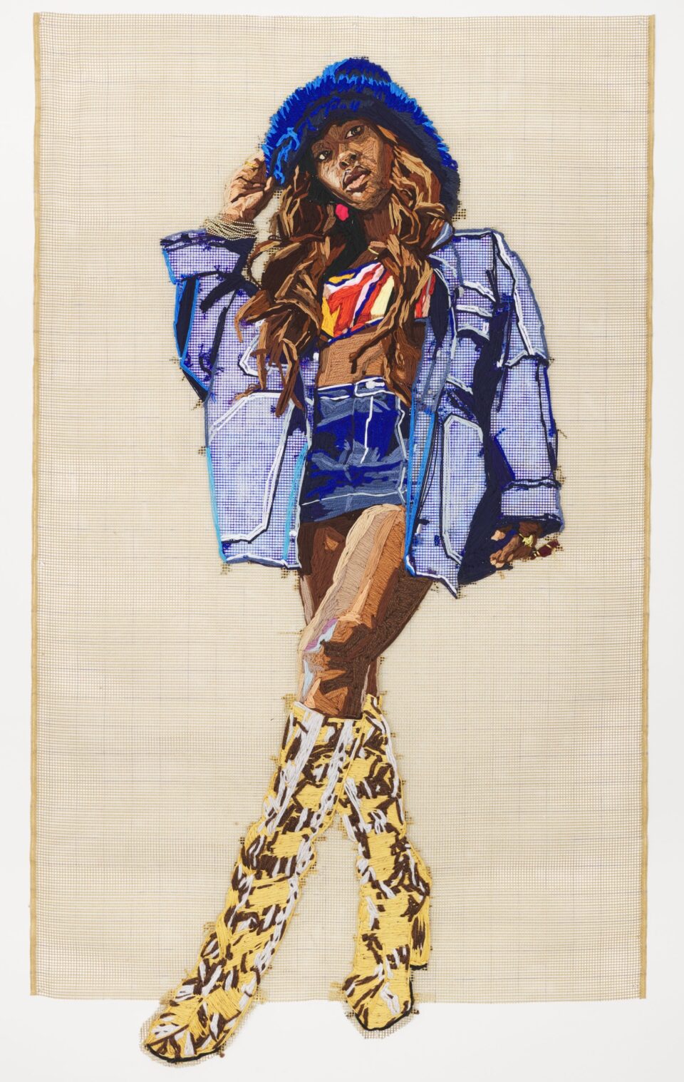 a large-scale embroidered portrait of a vibrantly-dressed Black woman against a yellow gridded background