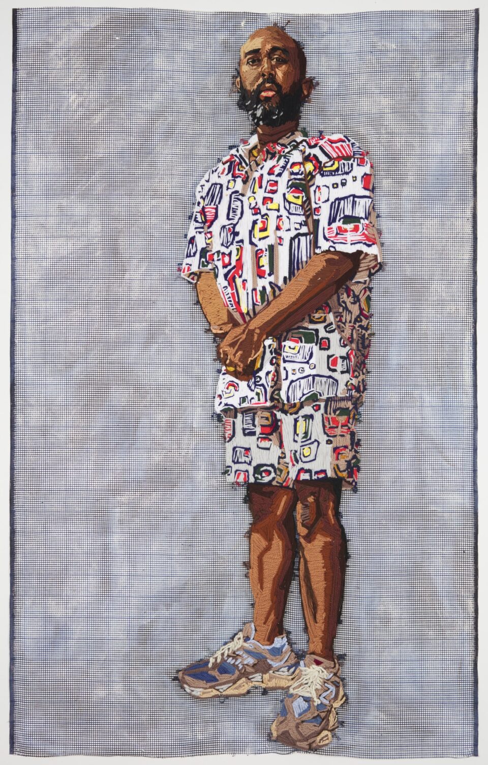 a large-scale embroidered portrait of a vibrantly-dressed Black man against a gridded background