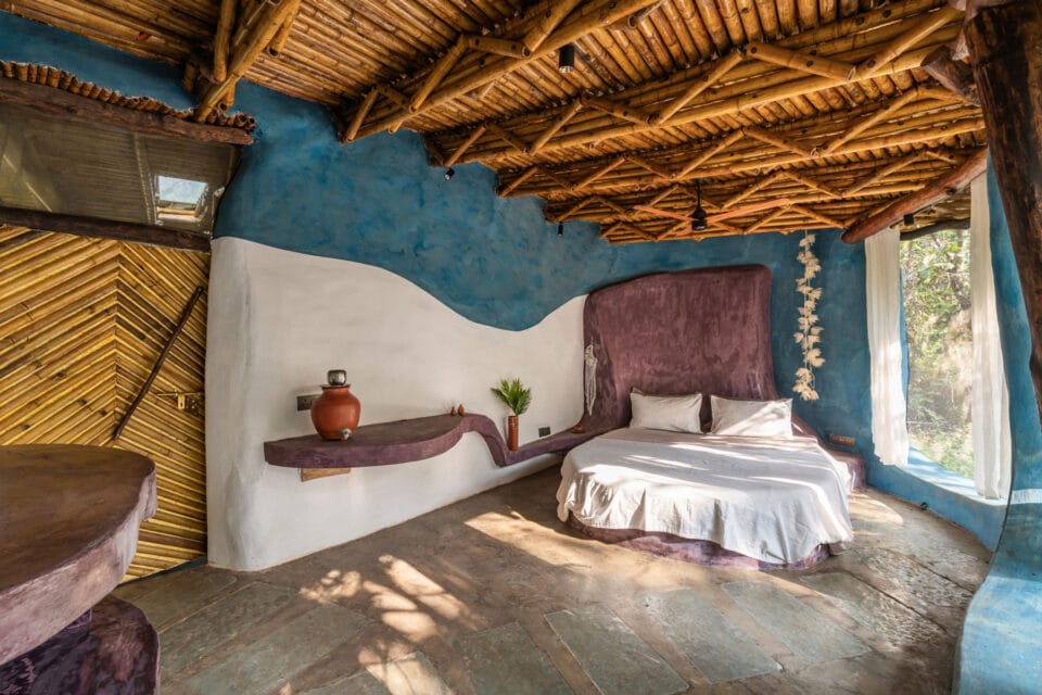 the interior of a biophilic residential design, with wood-beamed ceilings, organic walls, and earthy floors