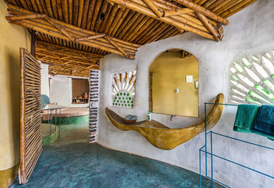 the interior of a biophilic residential design, with wood-beamed ceilings, organic walls, and earthy floors