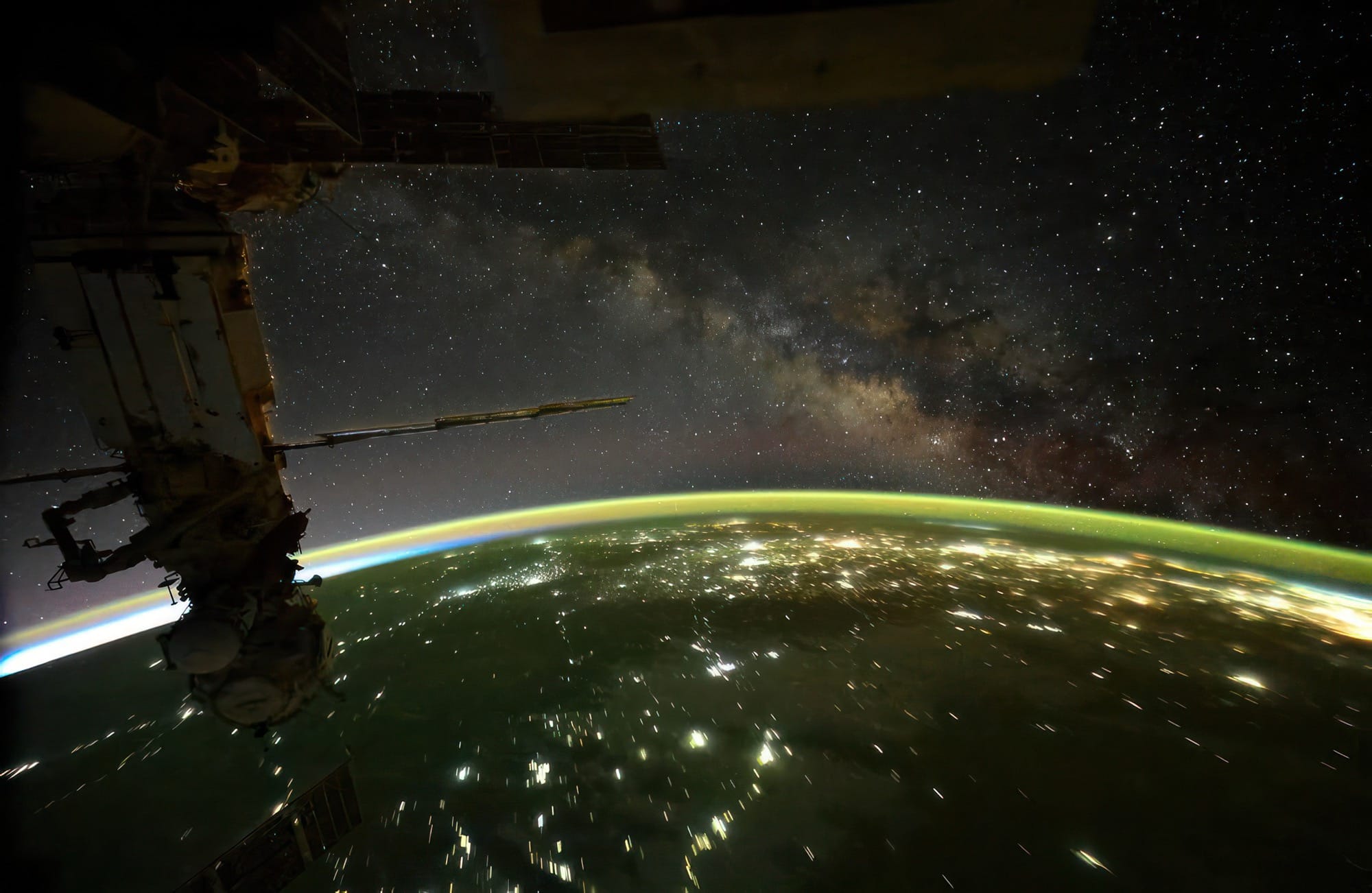 a view of the milky way from space with earth below