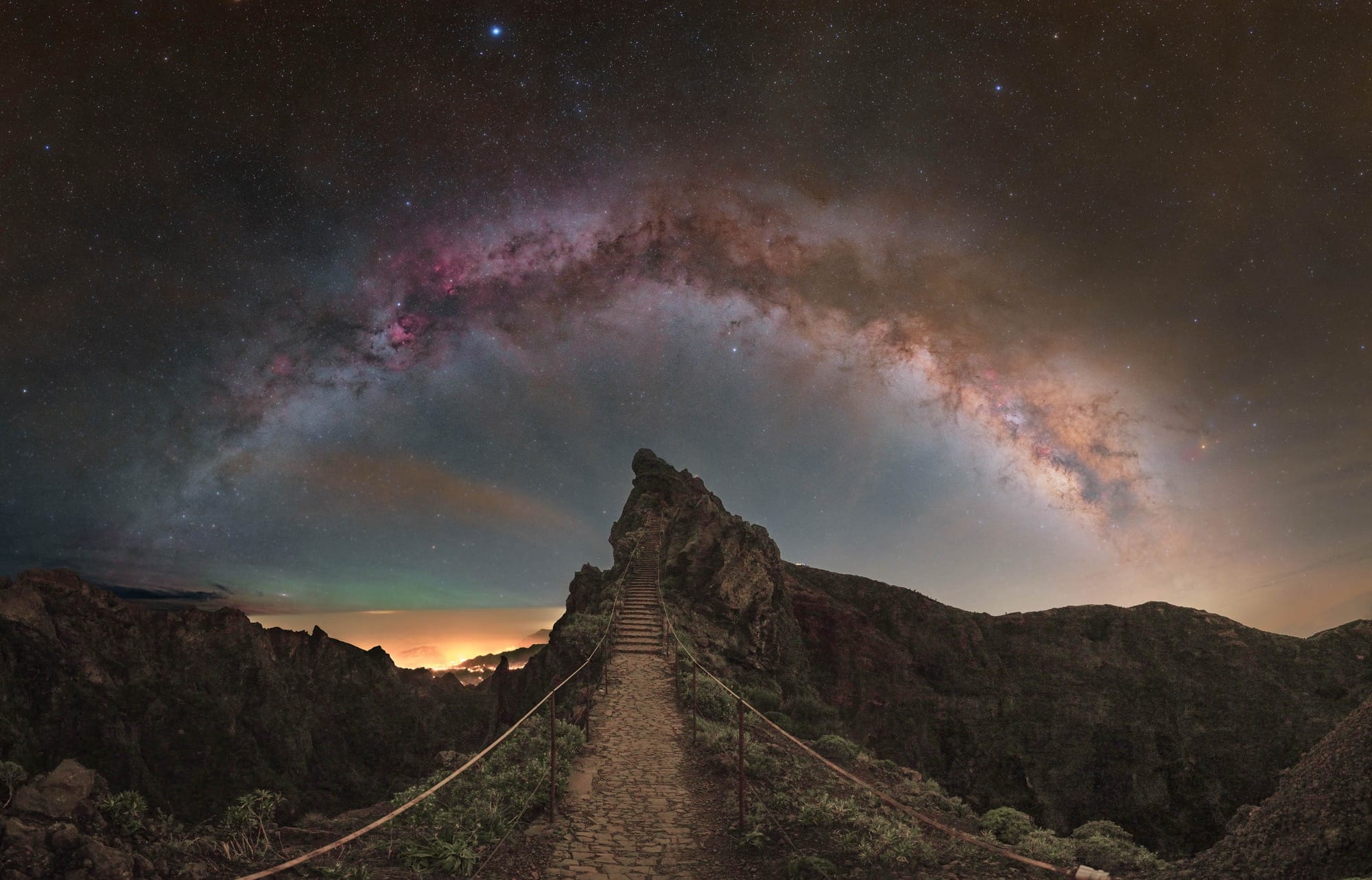 a path leads to a pointed stone under the milky way