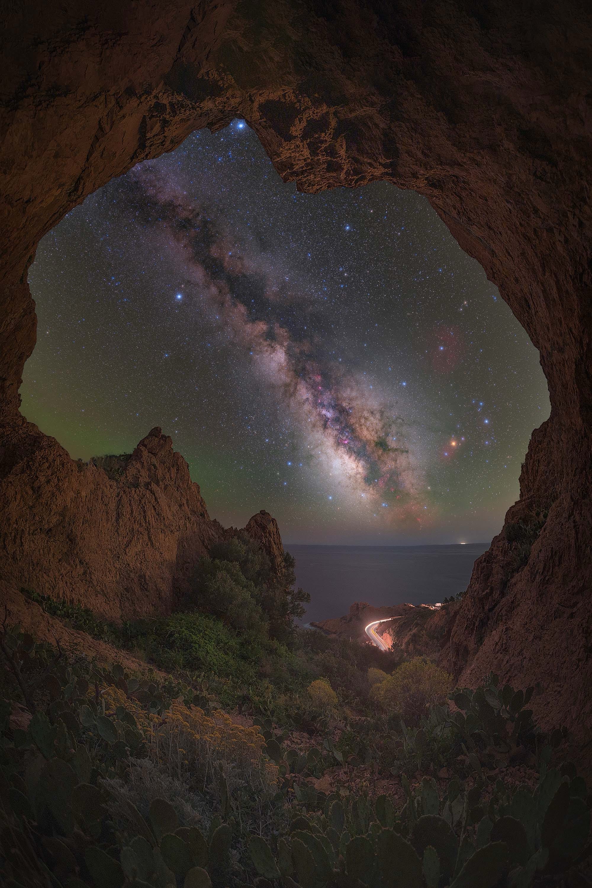 the milky way seen through a rock arch