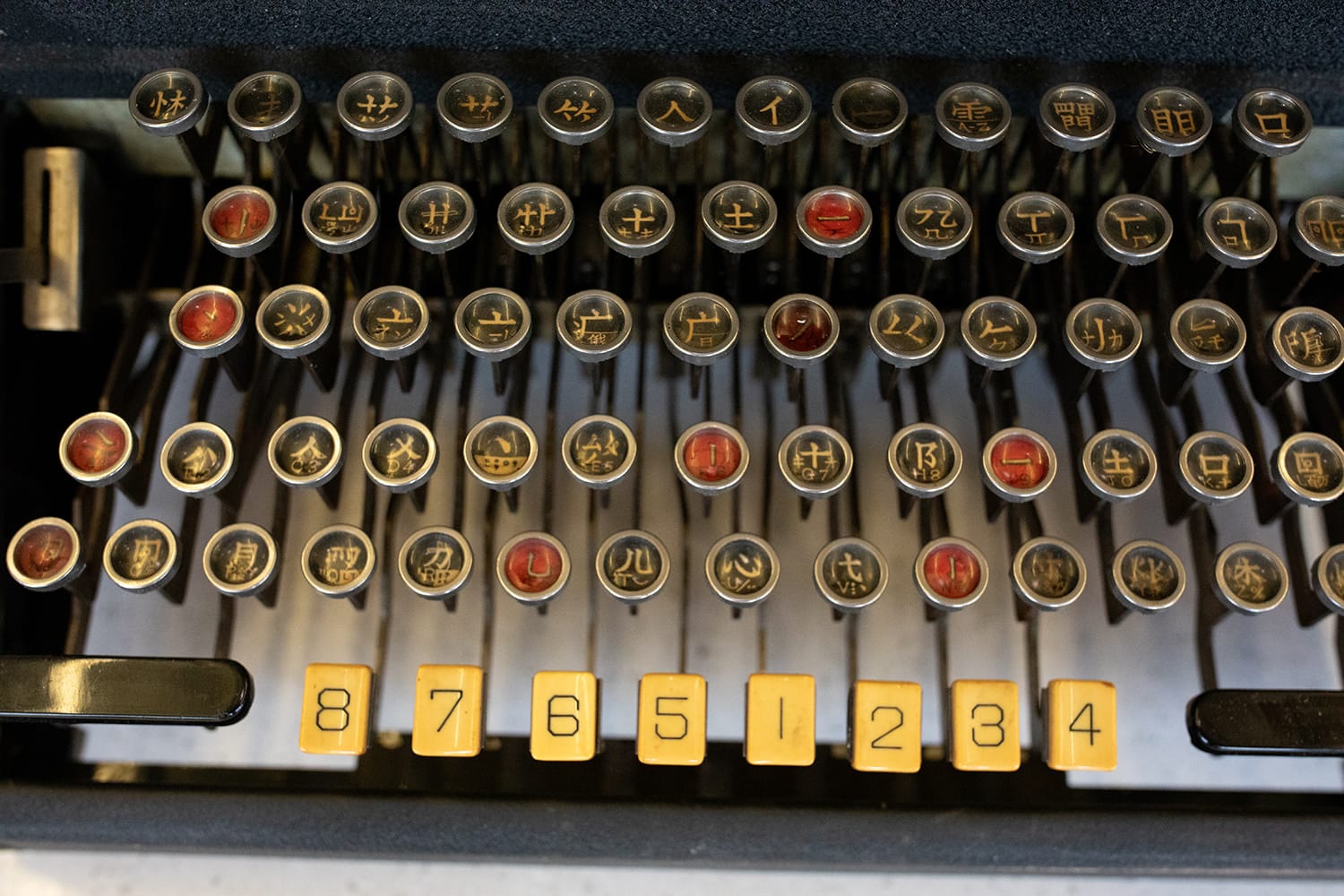 a keyboard of a typewriter with components of Chinese characters