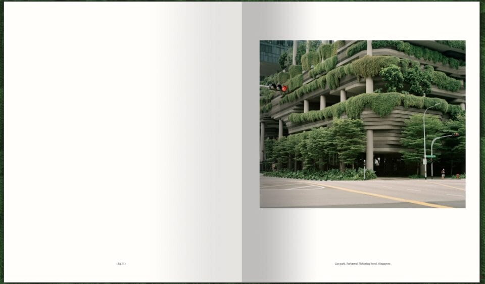 a spread of a photography book with an image on the right showing urban architecture almost completely covered in vines