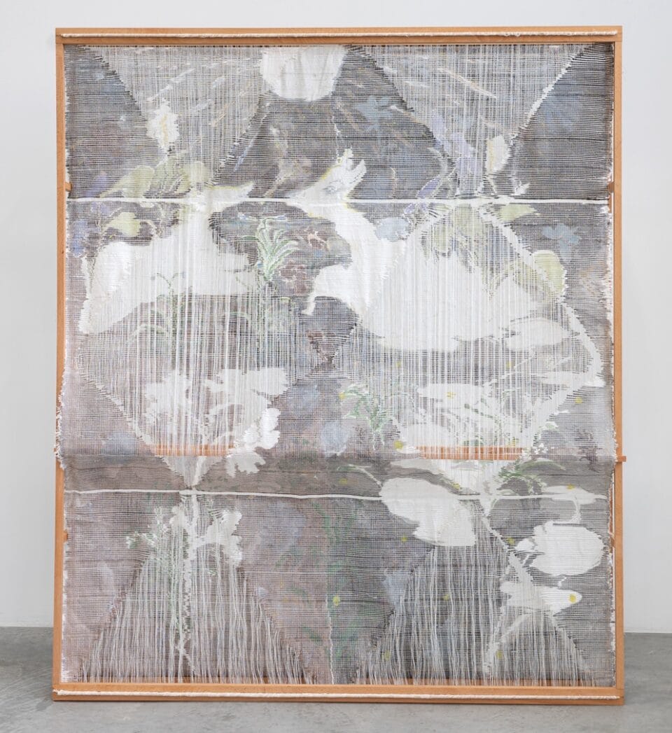 an abstract woven, sculptural artwork in a wooden frame