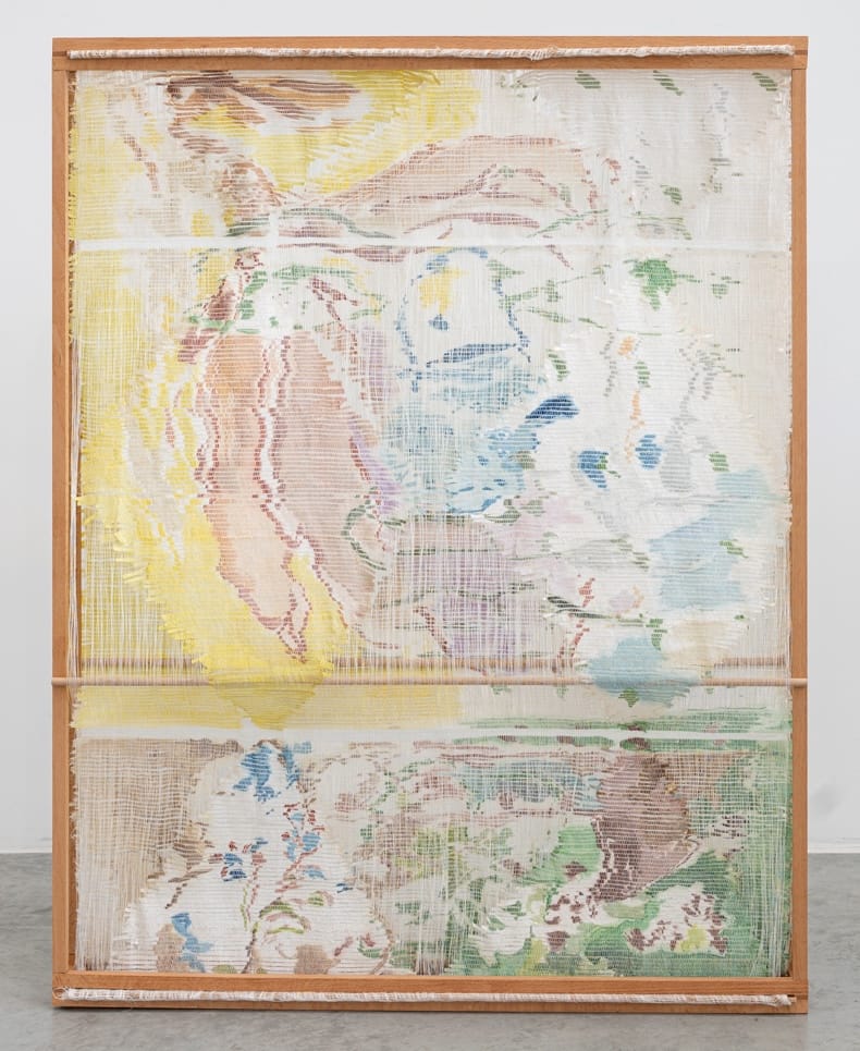 an abstract woven, sculptural artwork in a wooden frame