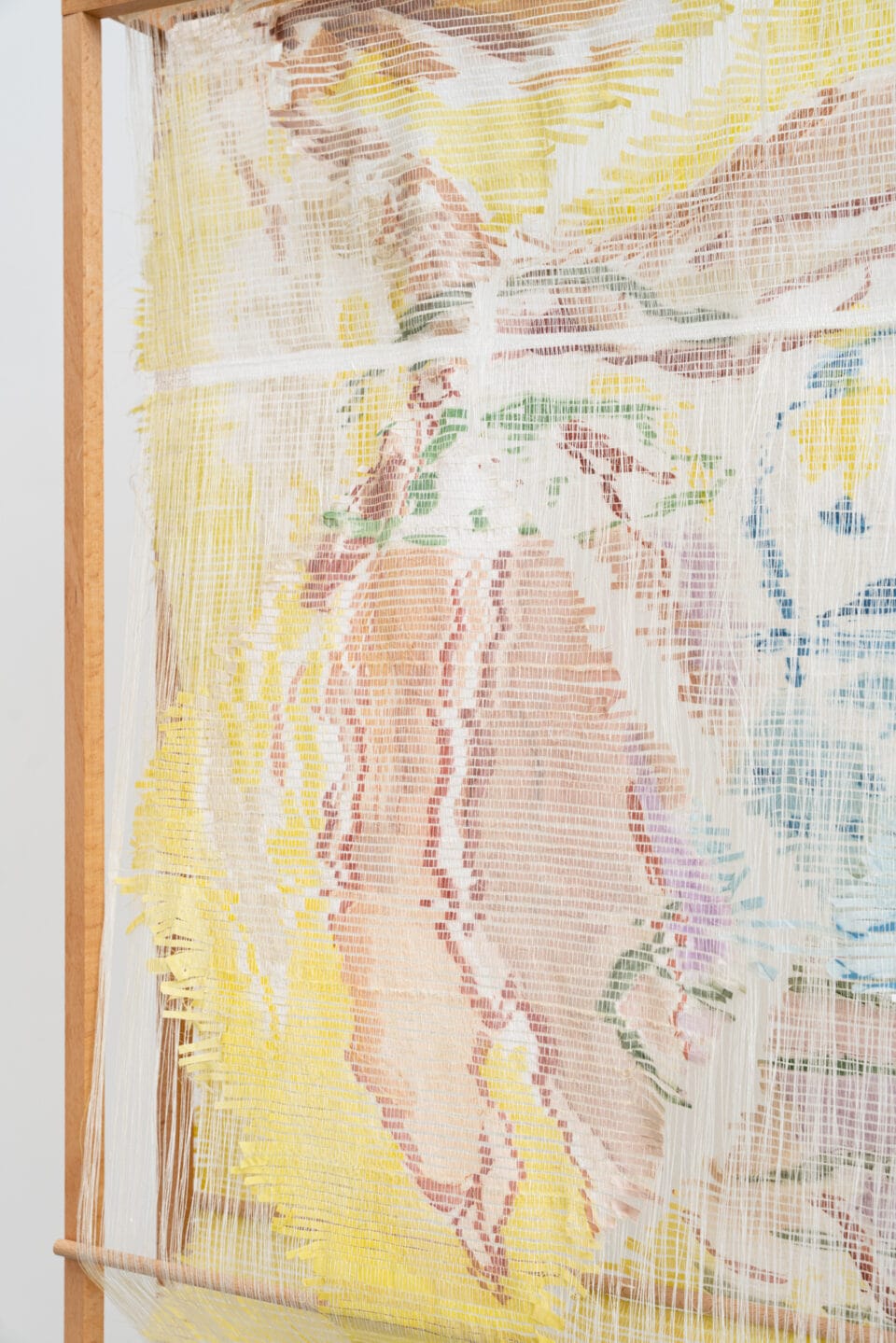 a detail of a woven, sculptural artwork in a wooden frame