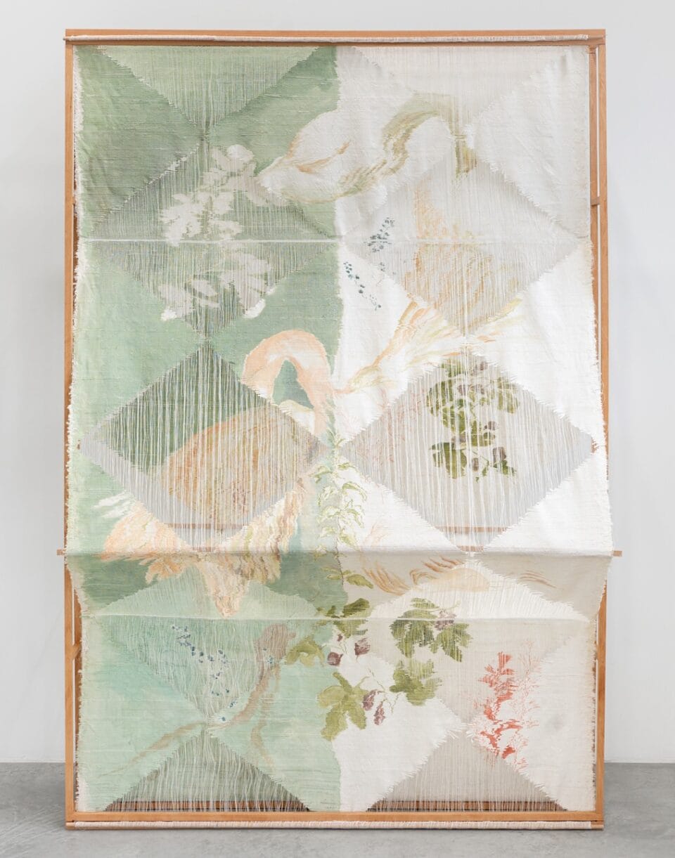 an abstract woven, sculptural artwork in a wooden frame