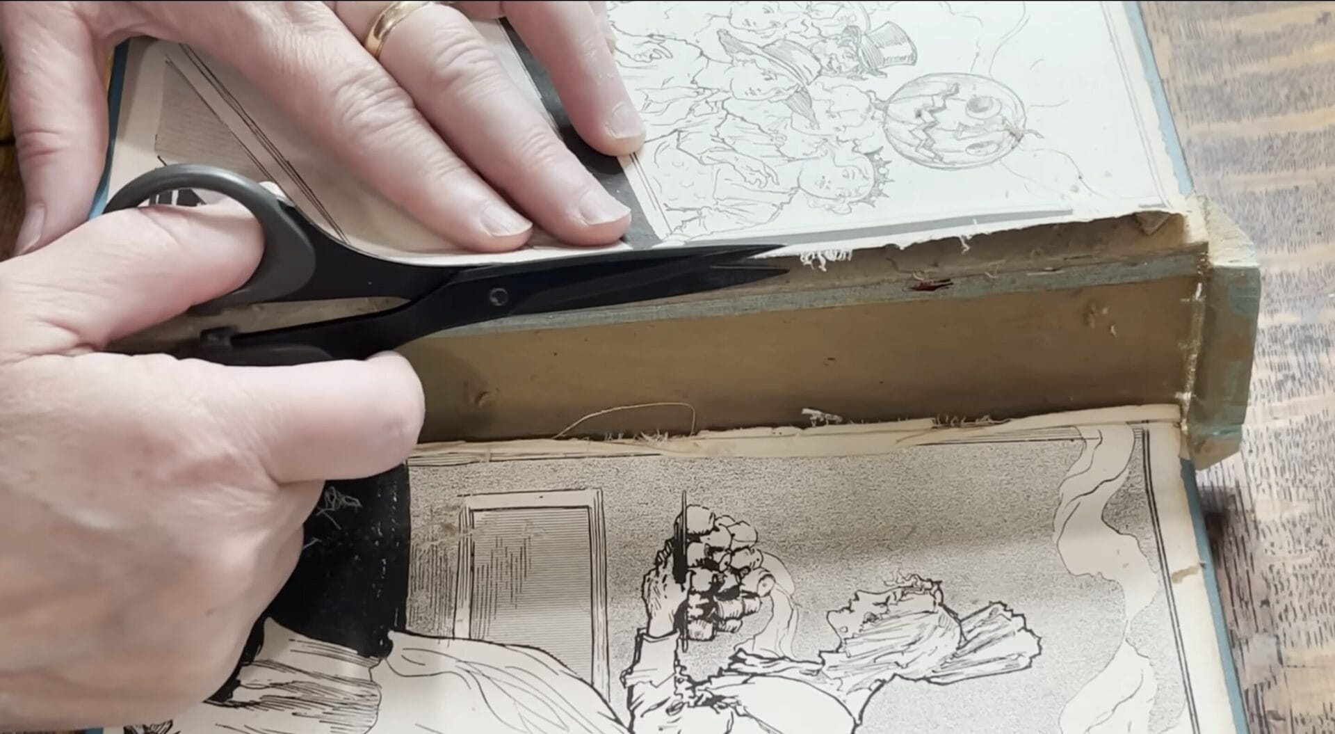 A close up cutting a book's spine open