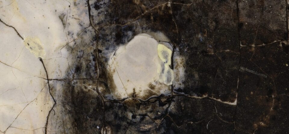 an extremely close-up detail of an oil painting with tiny daubs of paint and crackled texture