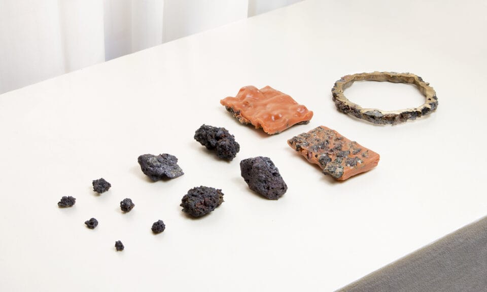 Bits of gravel sculpture arranged on a white table.