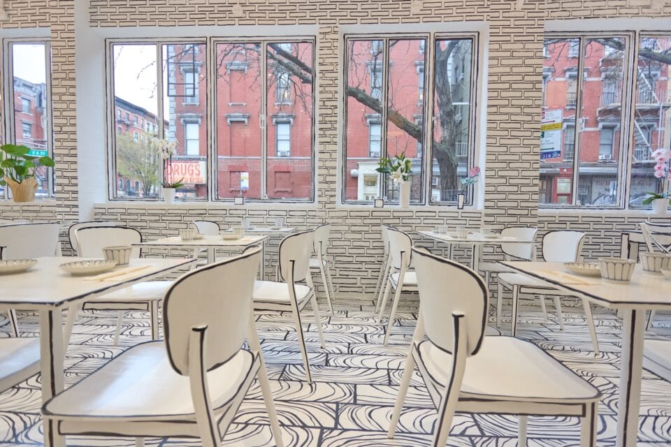 a restaurant all in black-and-white with line-drawn details on every surface so that it appears like a living 2D drawing