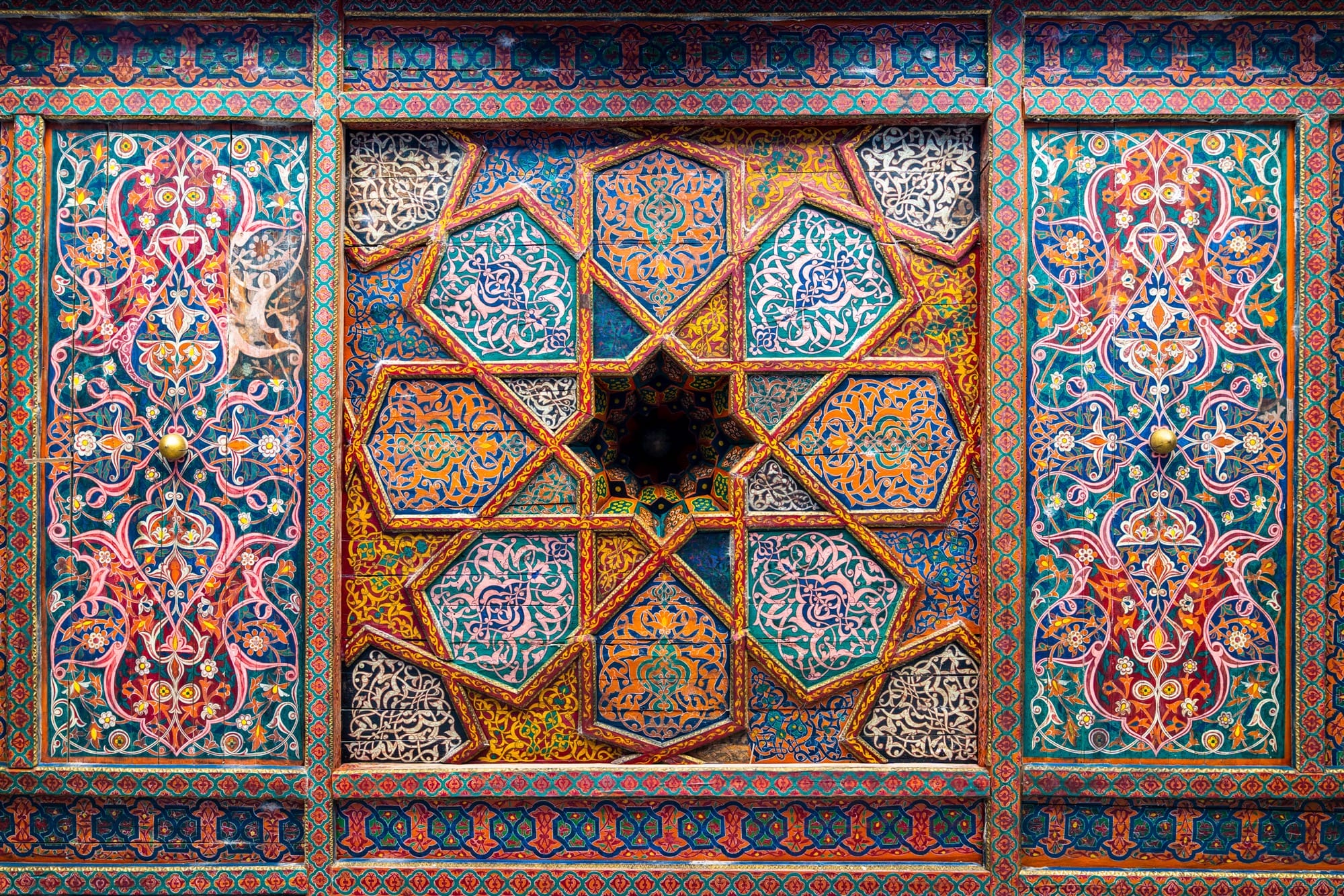a photograph of elaborate designs on the ceiling of a palace