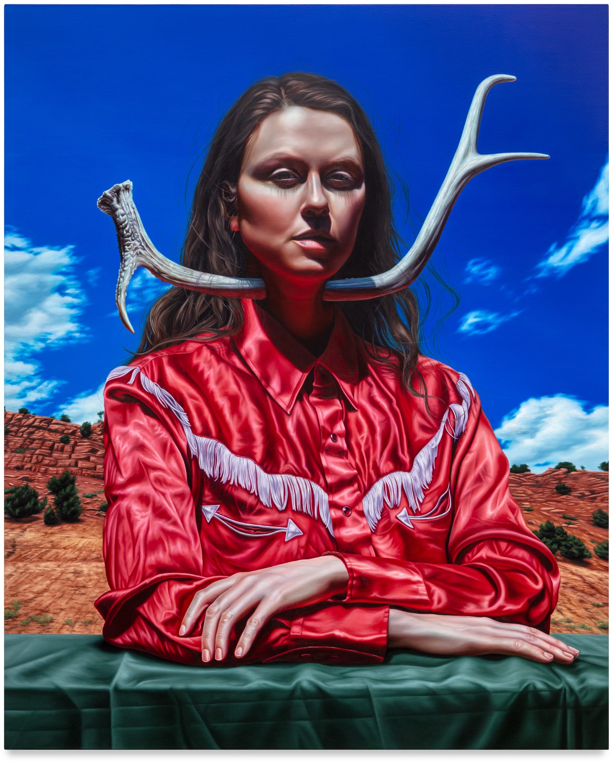 an oil painting of a woman in a red fringed Western shirt against a blue sky, staring straight at the viewer with an antler through her neck